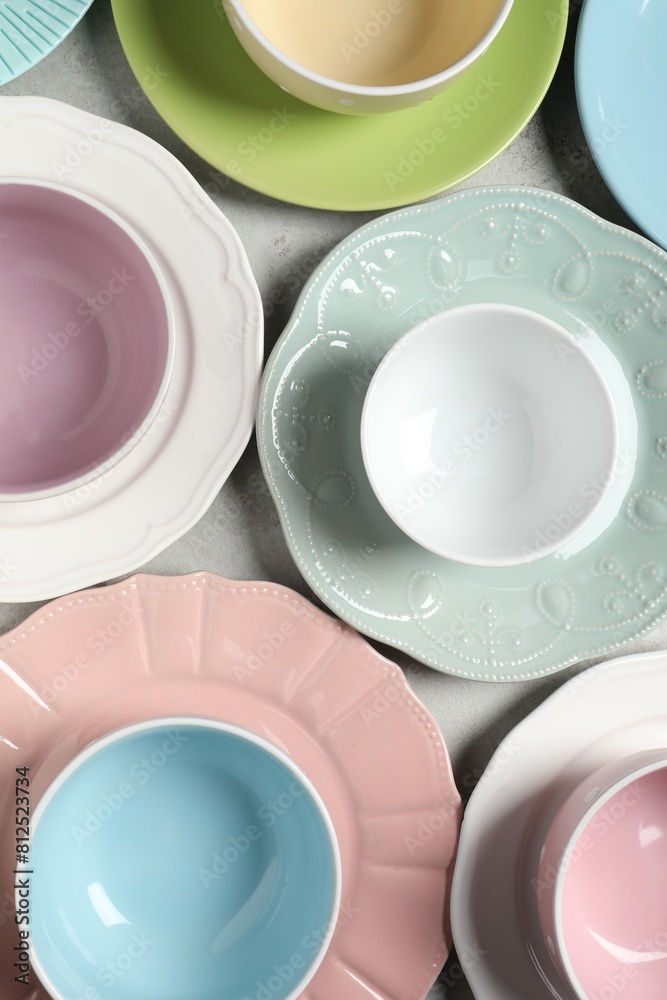 Beautiful ceramic dishware on light grey table, flat lay Beautiful ceramic dishware on light grey table, flat lay