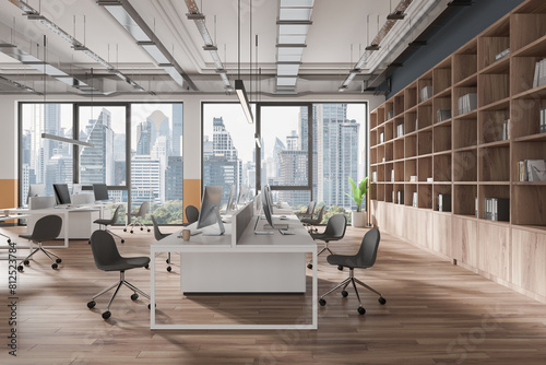 Gray open space office interior with book case