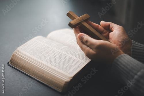 Christian woman reading bible in ancient Catholic temple. Devout Christian woman engages in prayer, fervently reading her Bible against religious background, embodying essence of Catholic devotion. photo