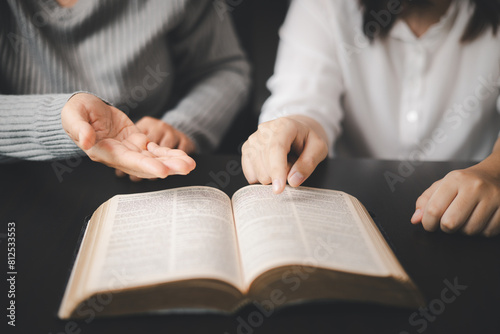 In the church, people to read Bible together, strengthening their faith as devout Catholics united by teachings of holy book. Christians are congregants join hands to pray and seek blessings of God.