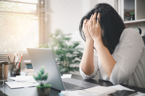 Stressed businesswoman, dealing with the pressures of work and the weight of depression, finds herself struggling in the office, feeling sleepy and overwhelmed by the demands of her job.