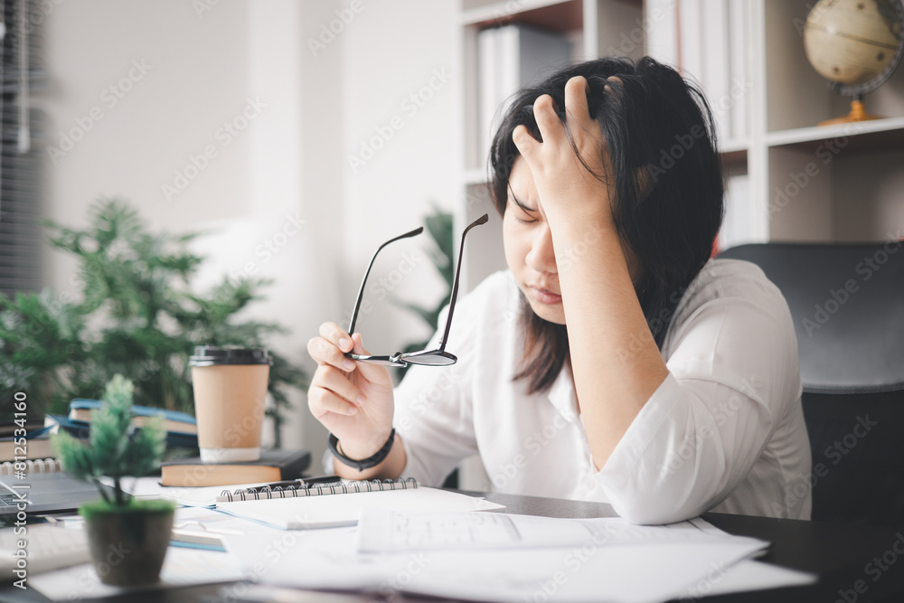 Stressed businesswoman, dealing with the pressures of work and the weight of depression, finds herself struggling in the office, feeling sleepy and overwhelmed by the demands of her job. Stressed businesswoman, dealing with the pressures of work and the weight of depression, finds herself struggling in the office, feeling sleepy and overwhelmed by the demands of her job.