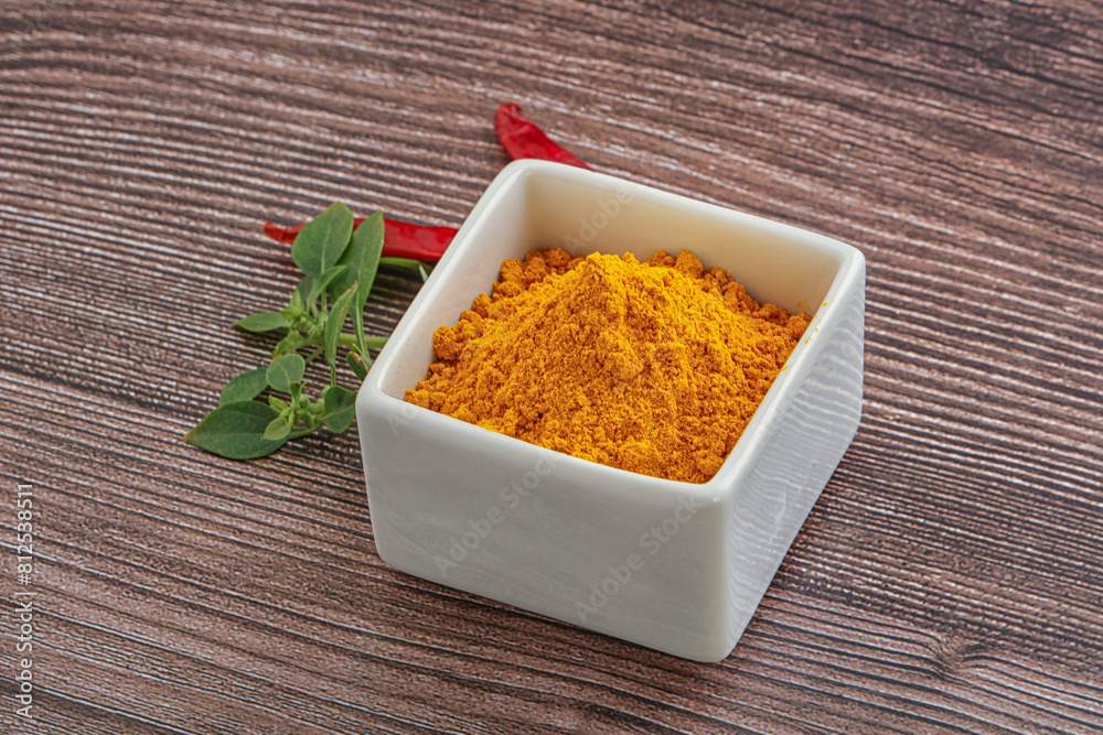 Yellow vibrant curcuma powder in the bowl Yellow vibrant curcuma powder in the bowl