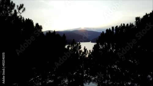 Drone fly through Trees - reveal Austrian Lake - Sunrise photo
