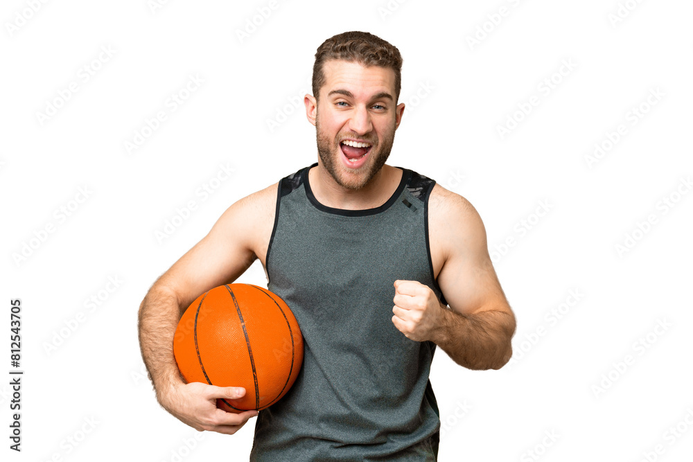 Handsome young man playing basketball over isolated chroma key background celebrating a victory in winner position