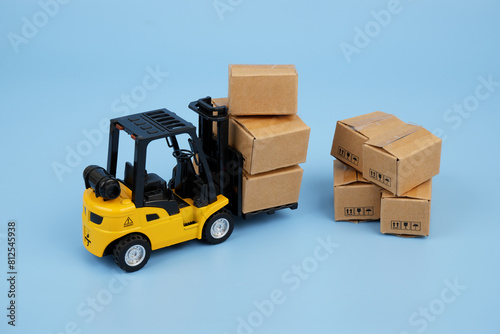 Many carton boxes and yellow forklift truck. 