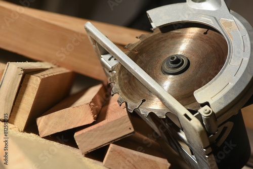 Circular saw and wooden boards close up background. Front view. Woodwork. photo