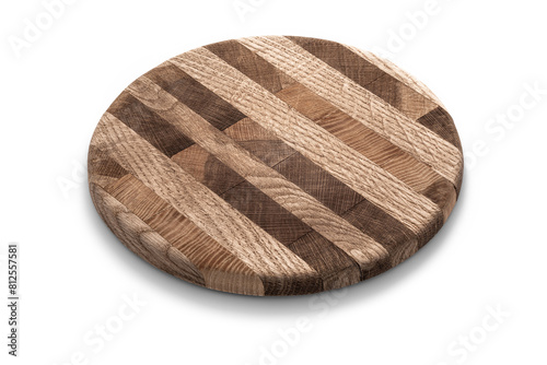 A circular striped wooden cutting board isolated against a white backdrop. © Mr. Music
