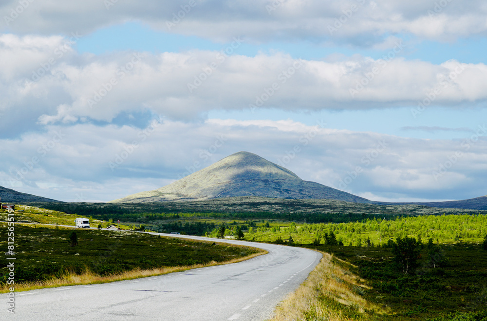 Fototapeta premium Open road with a view of mountains along the scenic Rondevegen over Venabygdsfjellet, Norwegian Scenic Route Rondane.