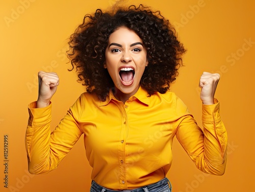 Ecstatic woman shout loud yeah fist up raise win lottery isolated bright shine color background