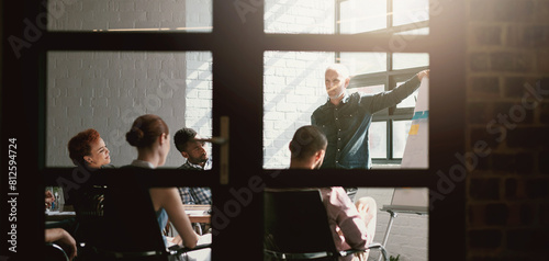 College, workshop and professor in classroom with group of phd students planning in meeting. University, training and lecture from mature man at whiteboard with solution, ideas and teaching people