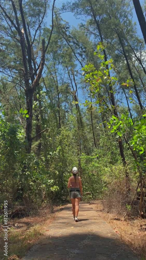 Woman enjoying solitary run through forest trail on sunny day, immersed in nature and practicing outdoor fitness for physical and mental well-being. Outdoor exercise and connection with nature. Woman enjoying solitary run through forest trail on sunny day, immersed in nature and practicing outdoor fitness for physical and mental well-being. Outdoor exercise and connection with nature.