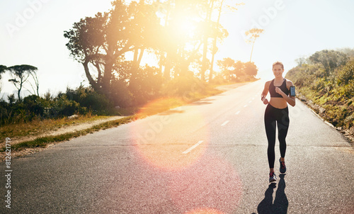 Running, woman and fitness for outdoor training, cardio workout or endurance challenge. Lens flare, wellness and female athlete person in road for exercise, marathon or performance in California