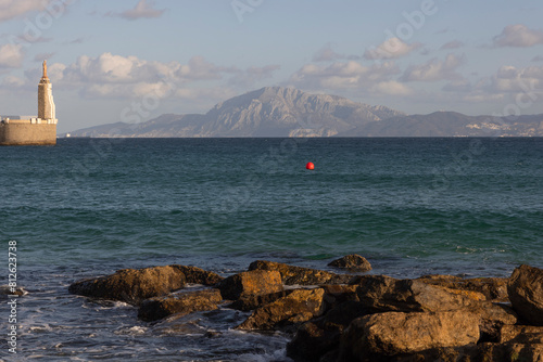 Sagrado corazon de Jesus landmark statue in Tarifa on the seashore of the Atlantic with view to Morocco at Strait of Gibraltar on a bright sunny day