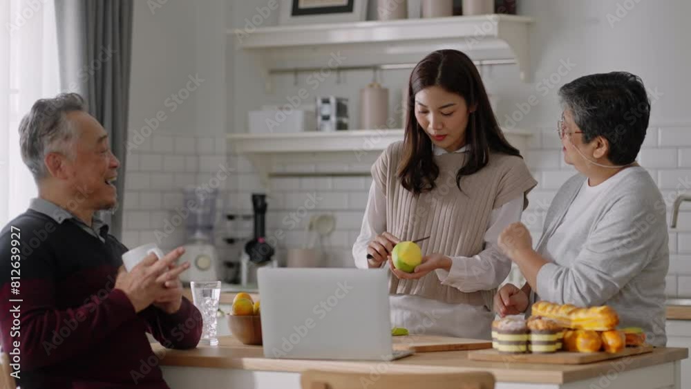 Happy mature old couple of parents and daughter cooking family dinner in kitchen,Mother teaching daughter to peel fruit,enjoying leisure,holiday,culinary hobby,active enjoy family retirement weekend. Happy mature old couple of parents and daughter cooking family dinner in kitchen,Mother teaching daughter to peel fruit,enjoying leisure,holiday,culinary hobby,active enjoy family retirement weekend.
