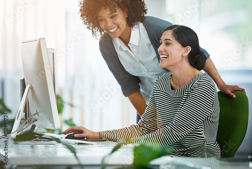 Business women, laughing and teamwork on computer for public relations, planning and project support in office. Excited mentor, copywriter or creative editor reading funny post for online publishing