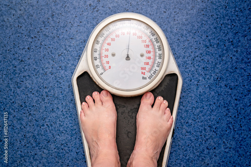 looking down standing weight scales, obesity overweight management, Australian general practice, GP doctor medical clinic, metric kilograms, metabolic syndrome, preventative health care