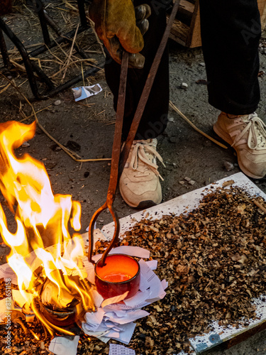 The process of Raku firing when glazed ceramics are taken from the kiln while glowing red hot and placed in a material that would be able to catch fire, such as sawdust or newspapers