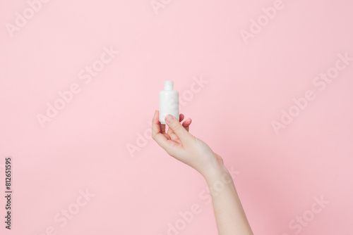 Hands hold glass unbranded bottle with serum or essential oil with pipette. Concept of beauty. Product cosmetic advertising