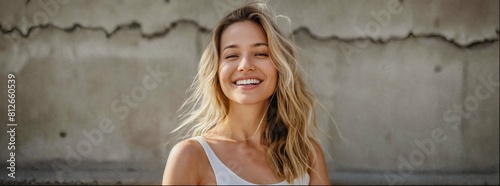 Woman is smiling slightly as if enjoying sunbathing outside. Her pose exudes confidence and grace, adding to the overall elegance photo