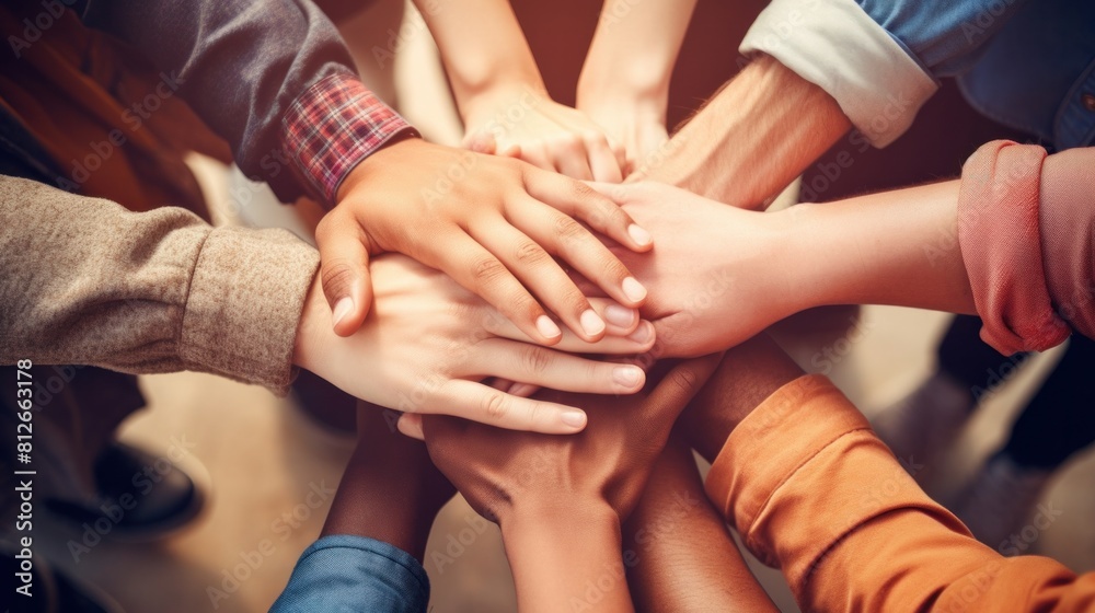 A young people placing their hands together. Friends with stack of hands showing unity and teamwork. A young people placing their hands together. Friends with stack of hands showing unity and teamwork.