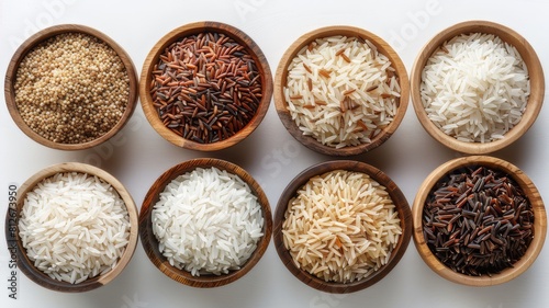 Various types and colors of rice; paddy rice, rice, brown coarse rice and white thai jasmine rice in wooden bowl isolated on white background, healthy eating concept