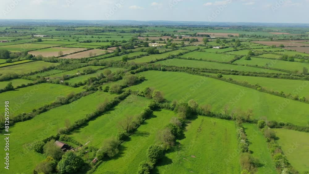 Slow flight over a patchwork of fields in England. Sunshine. Slow flight over a patchwork of fields in England. Sunshine.