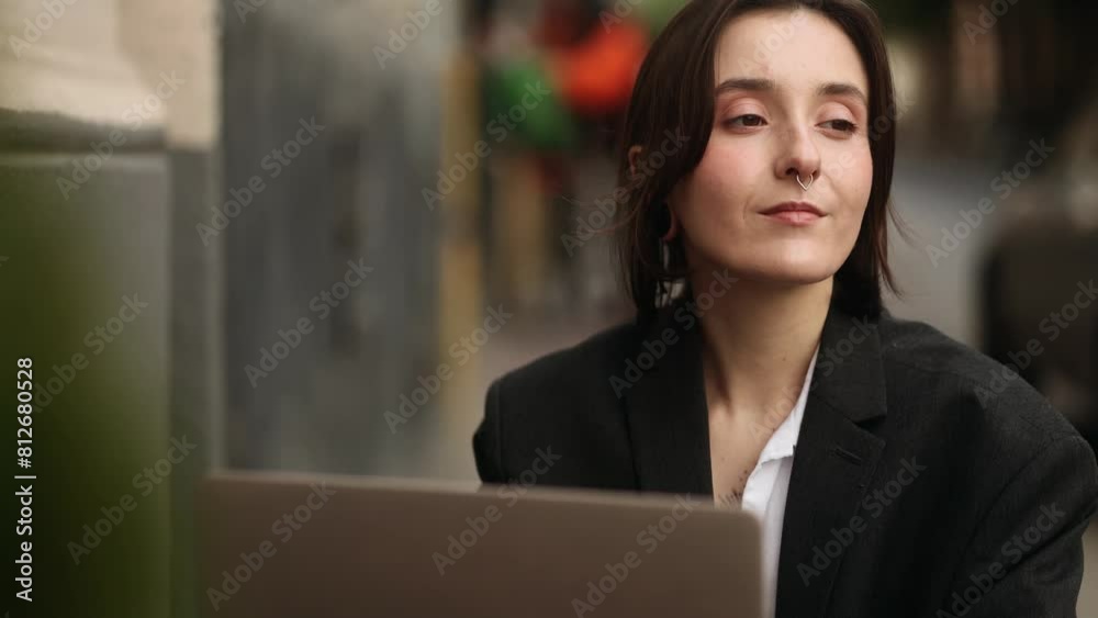 Beautiful young caucasian woman working online typing browsing products in internet store reading news checking email or social media profile on laptop computer at cafe outdoors Beautiful young caucasian woman working online typing browsing products in internet store reading news checking email or social media profile on laptop computer at cafe outdoors