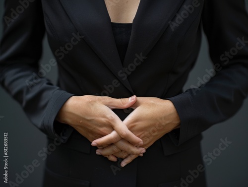 Simple yet impactful shot of a female CEOs torso in a black suit, conveying decisiveness and financial acumen
