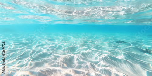 Underwater view of clear blue water, with light ripples and a white background. ocean underwater, beach underwater with white sand