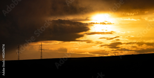 Fototapeta Naklejka Na Ścianę i Meble -  Silhouette of high voltage electric tower on sunset time.