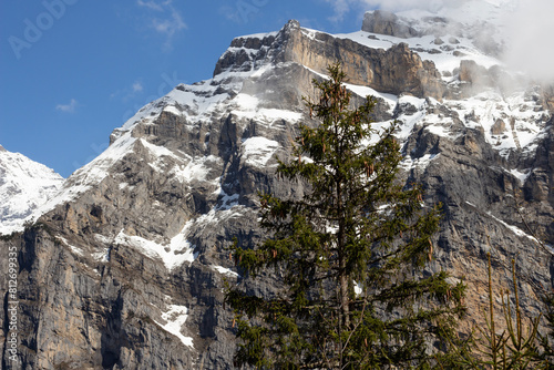Alpine mountains in Switzerland. Snowy peak against the blue sky. Tourist resort. Nature in Europe