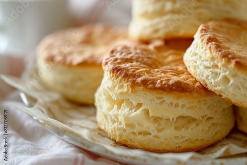Close-up of freshly baked biscuits on a white plate with a blurred background