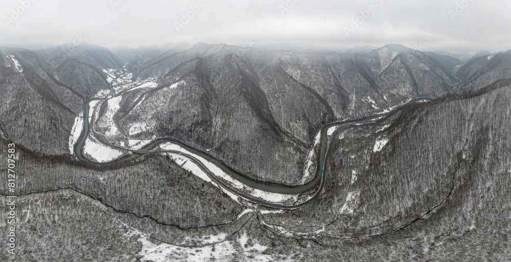 Obraz premium Severe frost at sunrise in the Carpathians, Transcarpathia, Ukraine. A drone flies over the tops of mountains shrouded in picturesque fog from river valleys