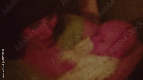 Old film strip of a young woman with a baby. 