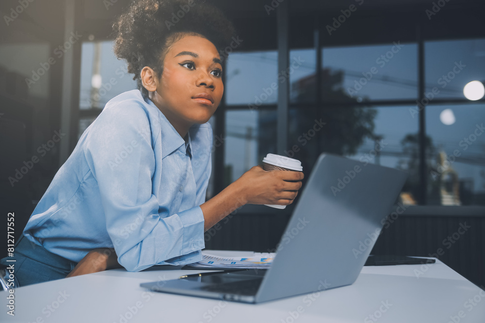 Bored young woman in the office working with a laptop and staring at computer screen Bored young woman in the office working with a laptop and staring at computer screen