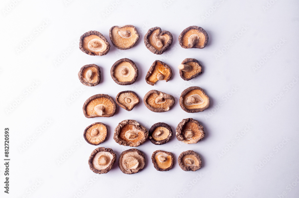 Dried shiitake mushrooms on white background flat lay copy space japanese cuisine Dried shiitake mushrooms on white background flat lay copy space japanese cuisine