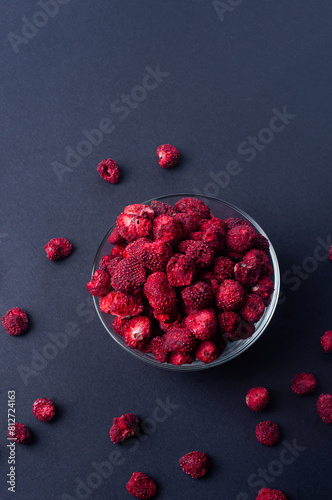 Dehydrated dry strawbberry on black background copy spac photo