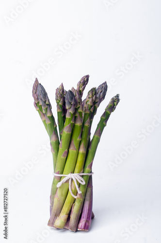 Bundle of asparagus on white background minimalist
aesthetic copy space