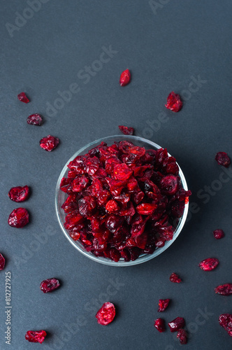 Dried cranberry on dark background flat lay top view