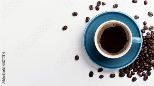 A blue cup of coffee on a white background with coffee beans scattered around it.