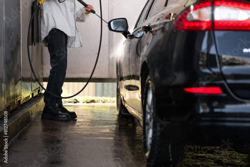 man washes his car at the car wash