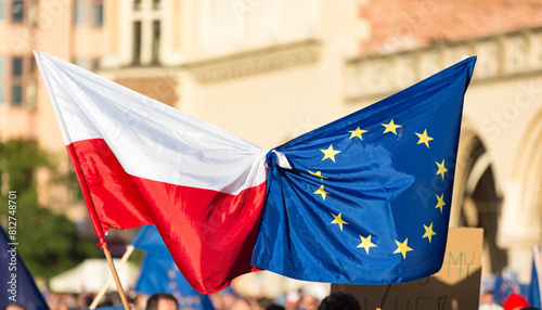 european union flagstied with flag of Poland waves on public demonstartion to support Polish memebrship in EU