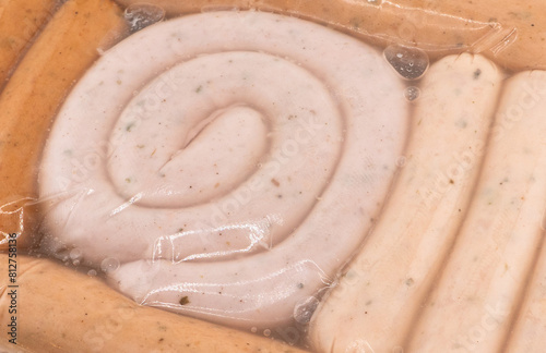 Sausages in vacuum plastic packaging texture background. Vacuum transparent packaging with fresh sausages. A pack of sausages in a vacuum foil 