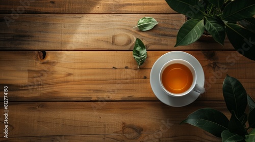 An overhead photo of a cup of tea on a wooden table. photo