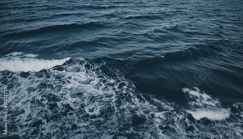 dark blue sea surface with waves splash and bubbles