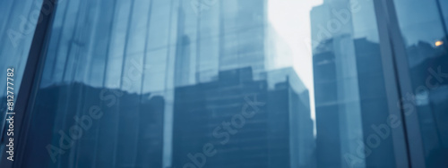 Blurred glass wall of modern business office building  business center  blur corporate business office background. Panoramic and perspective wide banner