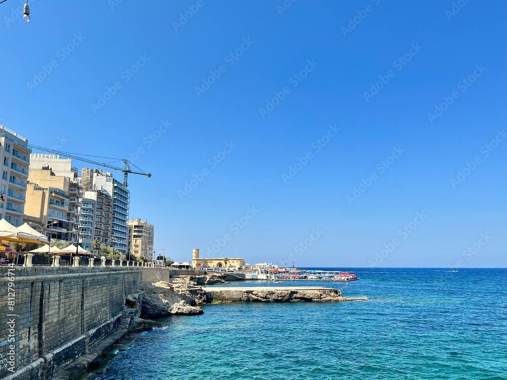view of the coastline of Sliema in Malta with its buildings borrowing from Mediterranean culture and the calm of the Mediterranean Sea on a sunny summer day
view of the coastline of Sliema in Malta with its buildings borrowing from Mediterranean culture and the calm of the Mediterranean Sea on a sunny summer day
