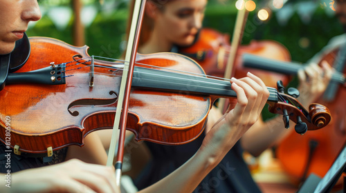 Elegant outdoor string quartet performance with violinists intensely playing at a garden event photo