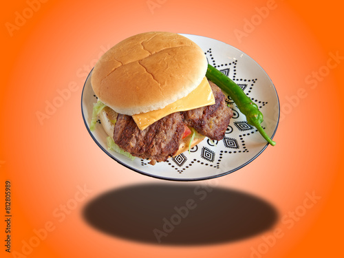 Pork burger on decorated plate Floating on gradiant orange Background